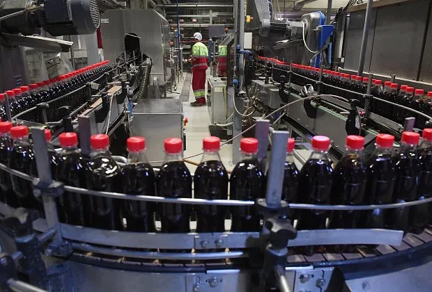 Сотрудник на линии розлива продукции в пластиковую тару на заводе Coca-Cola в Москве